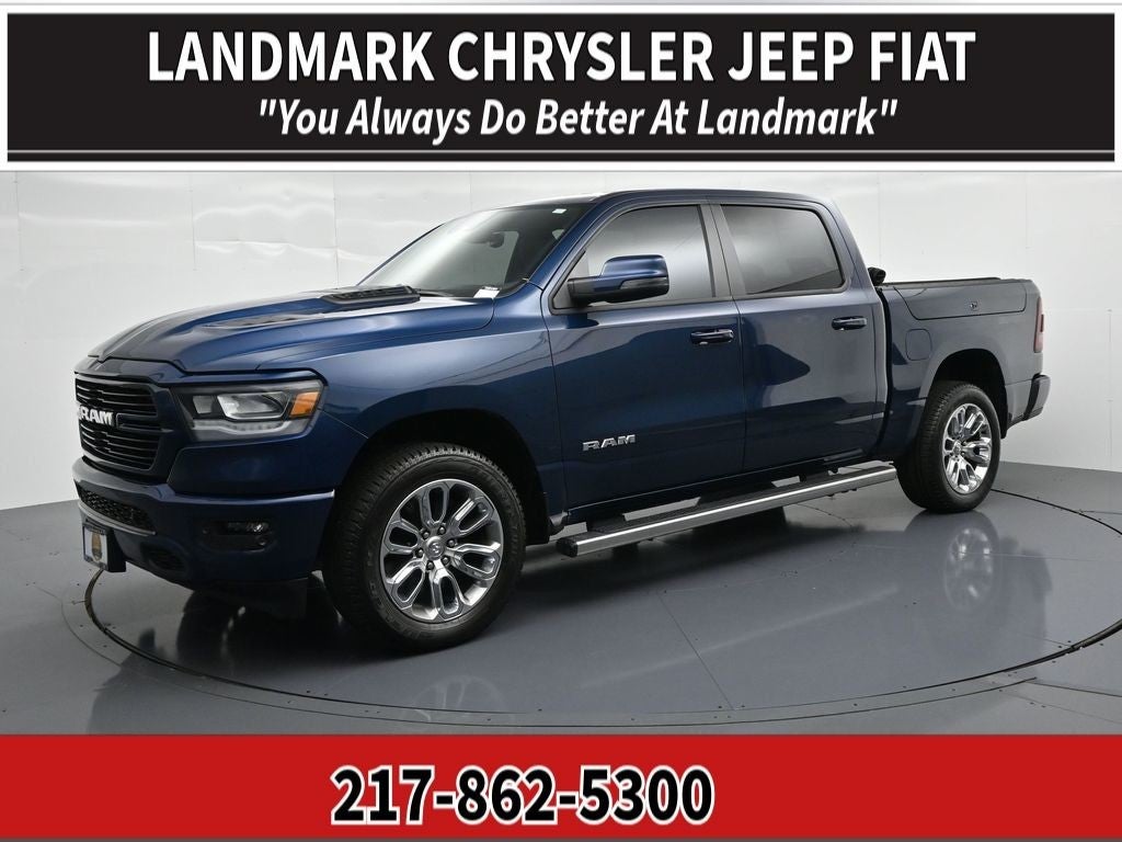 2023 RAM 1500 Laramie 4x4 Crew Cab 5'7" Box in Patriot Blue Pearlcoat — front three-quarter view